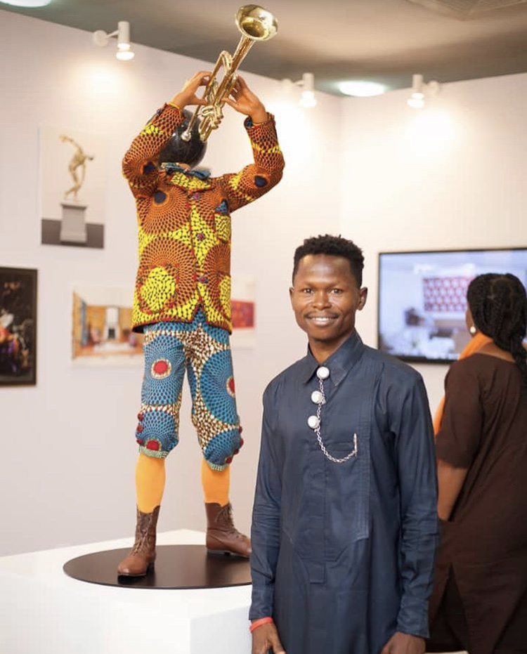 Artist Patrick Apkojotor in front of Yinka Shonibare's "Planets in my head"